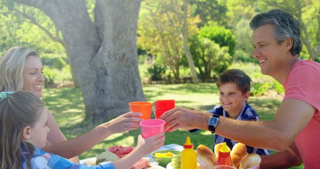 Happy Family Enjoying Picnic Together in Park - Download Free Stock Images Pikwizard.com