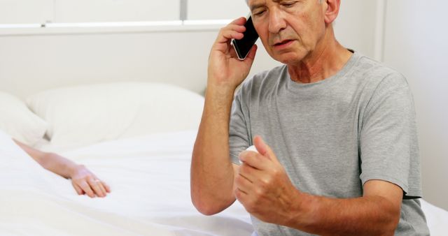 Concerned Senior Man Making Phone Call in Bedroom - Download Free Stock Images Pikwizard.com