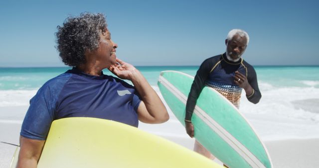 Senior Couple Smiling with Surfboards on Beach - Download Free Stock Images Pikwizard.com
