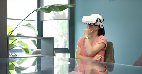 Businesswoman Engages in Virtual Reality on Office Break