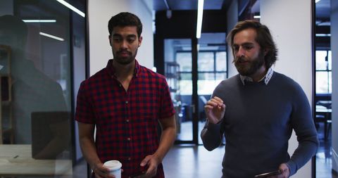 Diverse Male Professionals Conversing in Modern Office