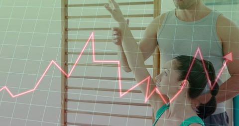 Coach guiding client arm alignment on stall bars with neon-pink analytics overlay