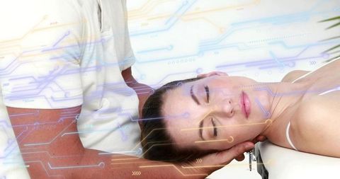 Woman receiving neck therapy from clinician hands with futuristic digital circuit overlay