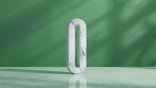 Standing marble zero sculpture on reflective surface