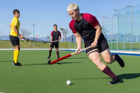 Dynamic Field Hockey Action on Green Synthetic Turf