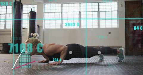 Performing push-up: fit woman training in gym with fitness data overlay and natural light