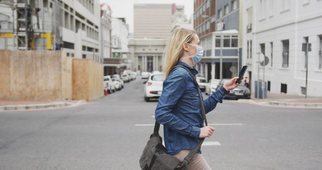 Young Woman Wearing Mask Using Smartphone while Walking in City - Download Free Stock Images Pikwizard.com