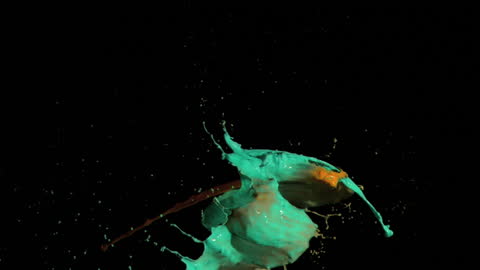 Dynamic Paint Splatter Against Black Backdrop