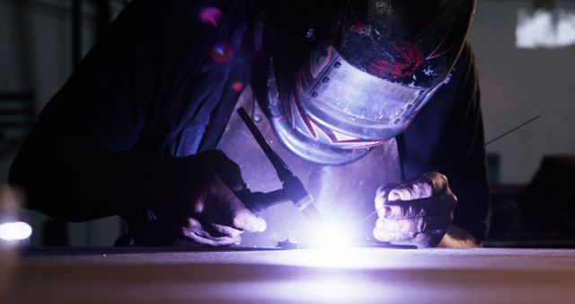 Skilled Welder Working with Intense Light in Dark Workshop - Download Free Stock Images Pikwizard.com