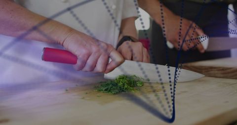 Chef Cutting Fresh Parsley with DNA Helix Digital Overlay