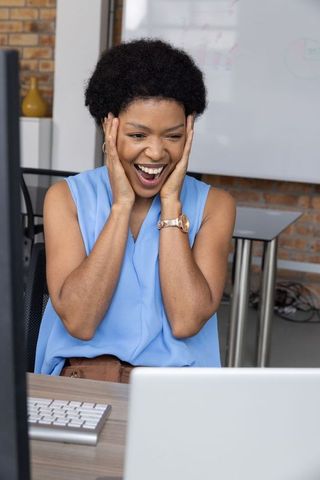 Excited Woman Reacting to Success in Modern Office