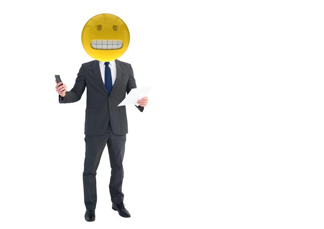 Businessman standing against a white background with digital composite emoji head showing a gritting teeth expression, holding a phone in one hand and papers in the other, implying feelings of stress or predicament. This can be used for illustrating emotions in the workplace, technology and communication themes, or digital art projects.