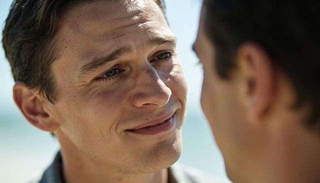 Smiling man sharing intimate seaside moment with partner, closeup emotional portrait
