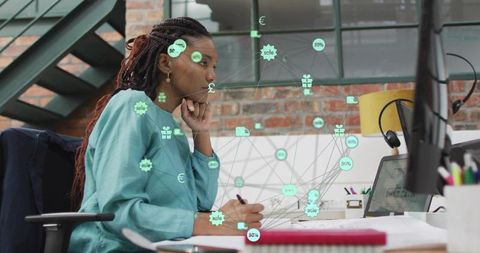 Creative professional analyzing network data overlays on monitor in modern loft workspace