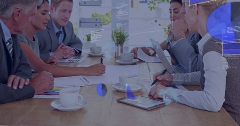 Executive team discussing strategy at conference table with tablet and analytics overlay