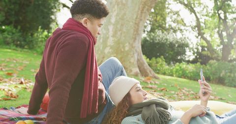 Relaxed Couple Enjoying Leisure Time Outdoors Using Smartphone - Download Free Stock Images Pikwizard.com