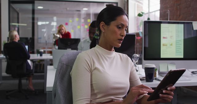 Businesswoman Working on Tablet in Modern Office Environment - Download Free Stock Images Pikwizard.com