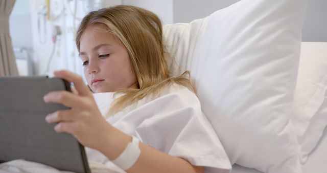Young Girl Relaxing in Hospital Bed Using Tablet for Entertainment - Download Free Stock Images Pikwizard.com