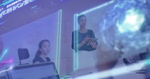 Presenting woman holding tablet with holographic interface during boardroom briefing