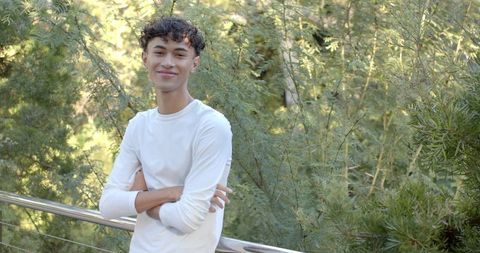 Young man relaxing on walkway amid greenery