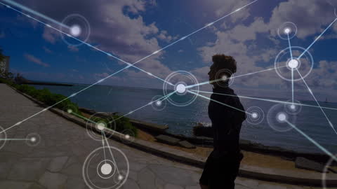 Man Running on Beach Promenade with Digital Network Overlay