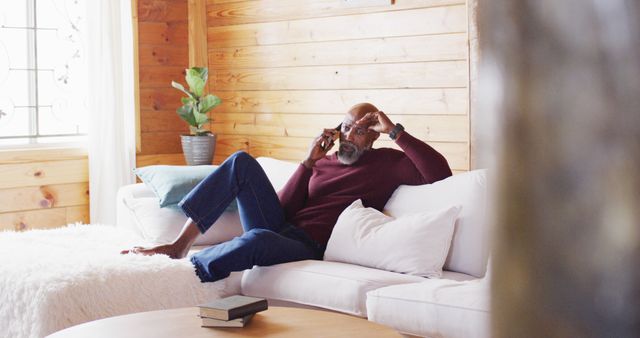 Mature Man Relaxing on Sofa Talking on Smartphone - Download Free Stock Images Pikwizard.com