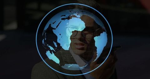 Business executive engages with digital globe hologram in futuristic setting