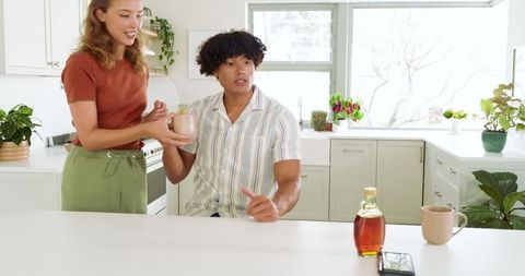 Joyful Couple Sharing Morning Coffee in a Modern Kitchen