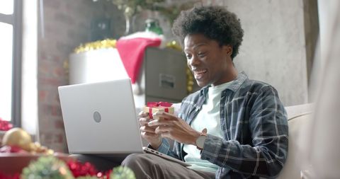 Joyful Man Opening Gift During Virtual Holiday Reunion - Download Free Stock Images Pikwizard.com