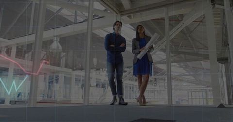 Architectural professionals walking in modern industrial workspace