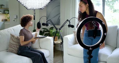 Two African American Women Podcasting at Home with Ring Light and Professional Microphones