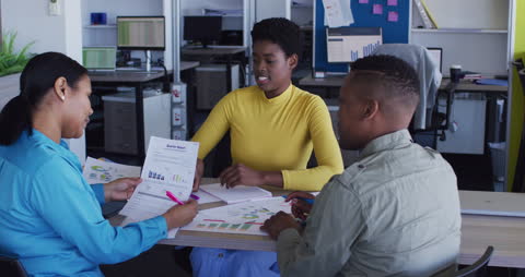 Diverse Business Team Analyzing Quarterly Report in Modern Office