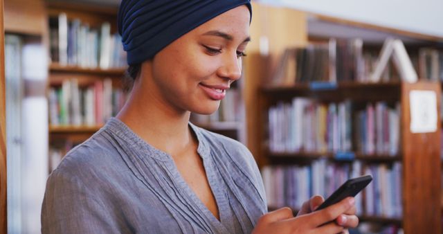 Smiling Woman Using Smartphone in Library Background - Download Free Stock Images Pikwizard.com