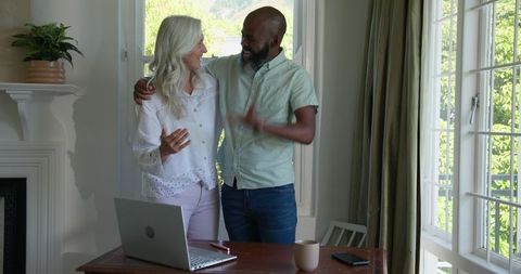 Happy Couple Celebrating Work Success Together at Home