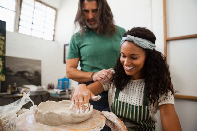 Man and woman engaged in pottery class. Woman shaping clay with assistance from man. Ideal for use in educational materials, promotional content for art workshops, creative learning, and teamwork illustrations.