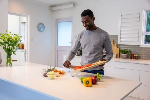 Man Preparing Healthy Meal in Modern Kitchen Interior