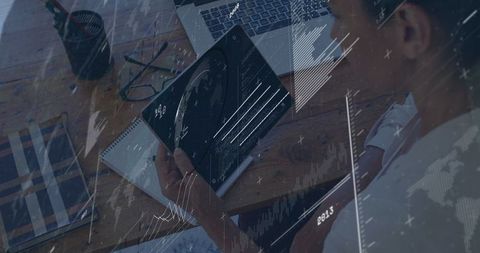 Mature professional analyzing data on tablet in office environment