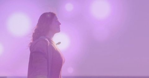 Woman in Serene Twilight with Pastel Sky Flares