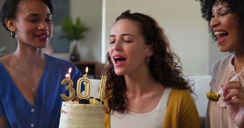 Diverse Friends Celebrating Woman's Birthday with Cake Candles