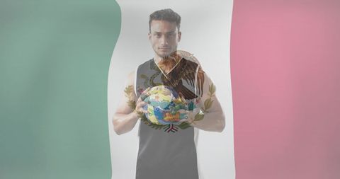 Confident Mexican Athlete Holding Soccer Ball Against National Flag