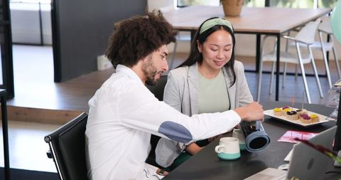 Colleagues Celebrating with Coffee and Cakes at Office Desk