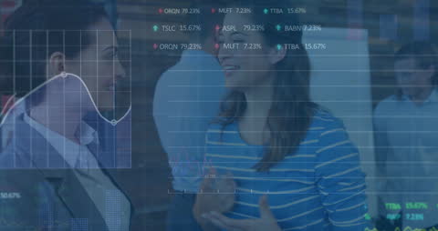 Diverse Female Colleagues Discussing Financial Data in Office Setting