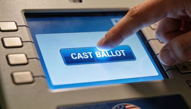 Pressing CAST BALLOT Button on Electronic Voting Terminal Touchscreen Closeup Elections