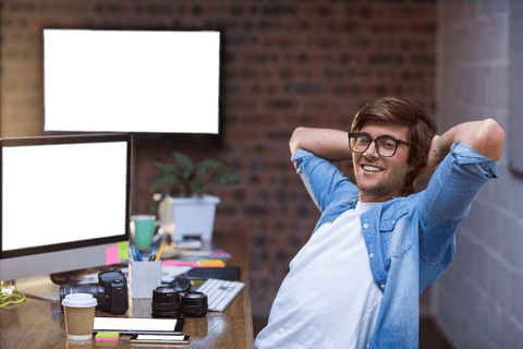 Relaxed entrepreneur sitting at desk in cozy office space