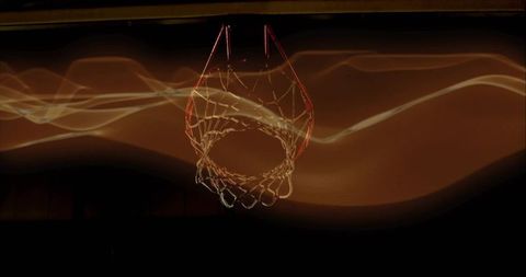 Basketball Hoop with Light Trails in Dark Arena