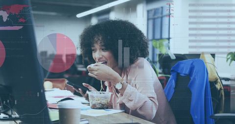 Businesswoman Analyzing Financial Data Eats Lunch at Desk Office
