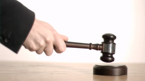 Gavel Striking Sound Block in Bright Office Environment