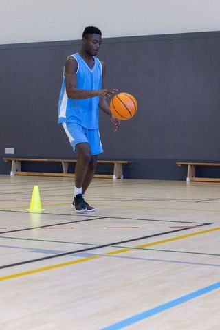 Athlete skillfully dribbling basketball during intense training session