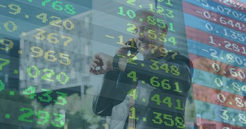 Executive checking watch and talking on phone with stock tickers overlay on glass facade