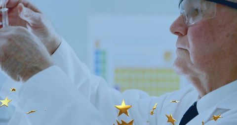 Senior lab technician drawing vaccine dose from vial in clinical lab wearing goggles